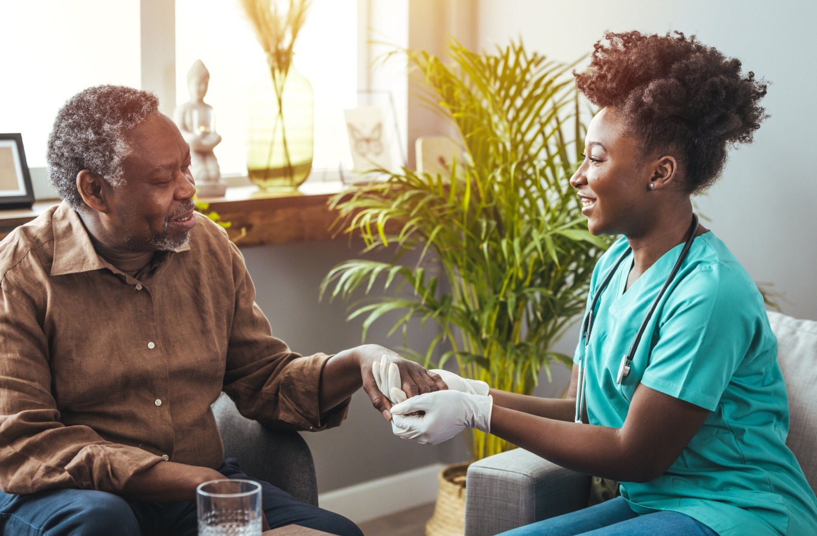 A senior with trouble using utensils works with a rehabilitation therapist to test their grip strength and dexterity